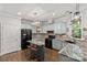 Charming kitchen with granite countertops, black appliances, light blue cabinets, and an island featuring barstool seating at 4025 Cherrybrook Dr, Mint Hill, NC 28227