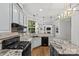 A bright kitchen boasts stainless steel appliances, granite counters, and ample cabinet space adjacent to the living area at 4025 Cherrybrook Dr, Mint Hill, NC 28227