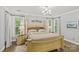 A bright, carpeted main bedroom boasts a large bed and bedside tables with ample natural light at 4025 Cherrybrook Dr, Mint Hill, NC 28227