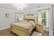 Spacious and well lit main bedroom with hardwood floors, crown molding, and large windows at 4025 Cherrybrook Dr, Mint Hill, NC 28227