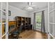 Well-lit office space with hardwood floors, built-in shelving, and large windows with natural light at 4025 Cherrybrook Dr, Mint Hill, NC 28227