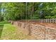 View of the retaining wall with the backyard beyond at 4025 Cherrybrook Dr, Mint Hill, NC 28227