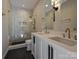 Modern bathroom featuring double sinks, granite countertops, and a walk-in glass shower at 4121 Selwyn Walk Ct, Charlotte, NC 28209
