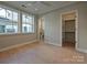 Bedroom with large windows, hardwood flooring, and walk-in closet and bathroom access at 4121 Selwyn Walk Ct, Charlotte, NC 28209