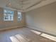 Spacious bedroom with hardwood floors, ceiling fan, and two windows providing ample light at 4121 Selwyn Walk Ct, Charlotte, NC 28209