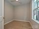 Bright bedroom with hardwood floors, ceiling fan, and natural light from the window at 4121 Selwyn Walk Ct, Charlotte, NC 28209