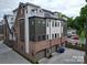 A townhome features a brick and siding exterior with garage and private rooftop deck in a modern neighborhood at 4121 Selwyn Walk Ct, Charlotte, NC 28209