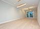 Bright living room featuring hardwood floors, modern lighting, and sliding glass doors at 4121 Selwyn Walk Ct, Charlotte, NC 28209