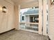 View of outdoor patio with stone flooring, white railings, and exterior light fixture at 4121 Selwyn Walk Ct, Charlotte, NC 28209