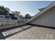 Expansive rooftop terrace showcasing brick pavers, white railings, and neighborhood views on a sunny day at 4121 Selwyn Walk Ct, Charlotte, NC 28209