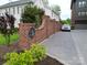 Street view of home featuring a brick entrance wall and landscaping at 4121 Selwyn Walk Ct, Charlotte, NC 28209