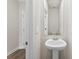 Bathroom featuring a pedestal sink with modern fixtures, white walls, and tile floors at 415 Luna Ln, Shelby, NC 28152