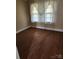 Bedroom featuring hardwood floors, windows with vintage curtains, and neutral walls at 423 Tot Dellinger Rd, Cherryville, NC 28021