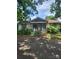Quaint exterior with red and white trim, covered porch, and mature trees at 423 Tot Dellinger Rd, Cherryville, NC 28021