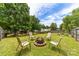 Enjoy this backyard with a fire pit and four chairs at 4321 Timberwood Dr, Gastonia, NC 28056