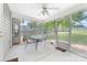 Screened-in patio with ceiling fan, table, and chairs, overlooking a fenced-in backyard with a playset at 4321 Timberwood Dr, Gastonia, NC 28056