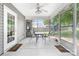 Screened-in patio with ceiling fan, table, and chairs, overlooking a fenced-in backyard with a playset at 4321 Timberwood Dr, Gastonia, NC 28056