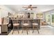Well-equipped basement bar area with bar seating, adjacent to a rec room at 4386 Oldstone Dr, Harrisburg, NC 28075