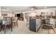 Basement bar area with bar seating and a full-sized refrigerator, and view into the recreation space at 4386 Oldstone Dr, Harrisburg, NC 28075