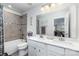 Bathroom featuring tiled shower and tub combination, dual sinks, and white cabinets at 4386 Oldstone Dr, Harrisburg, NC 28075