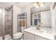 Modern bathroom with a walk-in shower, white vanity, and stylish mirror at 4386 Oldstone Dr, Harrisburg, NC 28075