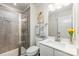 Modern bathroom featuring a tiled shower, a vanity with a sink, and decorative accents at 4386 Oldstone Dr, Harrisburg, NC 28075