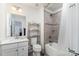 Bathroom featuring a shower-tub combination, a toilet, vanity with storage, and a large mirror at 4386 Oldstone Dr, Harrisburg, NC 28075