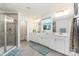 Bright bathroom featuring double sinks, a glass-enclosed shower, and stylish fixtures at 4386 Oldstone Dr, Harrisburg, NC 28075