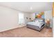 Cozy bedroom with comfortable Queen-sized bed, neutral decor, and ample natural light at 4386 Oldstone Dr, Harrisburg, NC 28075