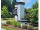 Grantham community entrance features a stone pillar and manicured landscaping at 4386 Oldstone Dr, Harrisburg, NC 28075