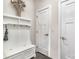 Functional entryway has a built-in bench, storage, and coat hooks for organization at 4386 Oldstone Dr, Harrisburg, NC 28075