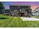 Spacious backyard featuring a two-story house with a deck and ample green space at 4386 Oldstone Dr, Harrisburg, NC 28075
