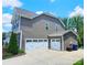 Spacious home featuring a three-car garage and neutral siding at 4386 Oldstone Dr, Harrisburg, NC 28075