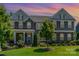 Charming two-story home boasting a landscaped yard, stone accents, and welcoming front porch at 4386 Oldstone Dr, Harrisburg, NC 28075