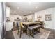 Open floor plan features a kitchen with an island and an eat-in table with seating at 4386 Oldstone Dr, Harrisburg, NC 28075