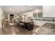 Open concept kitchen with bar stool seating overlooks living room with fireplace at 4386 Oldstone Dr, Harrisburg, NC 28075
