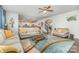 Open living room features hardwood floors, ceiling fan, and multiple sofas at 4386 Oldstone Dr, Harrisburg, NC 28075