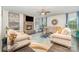 Inviting living room with a stone fireplace, comfortable seating, and a ceiling fan at 4386 Oldstone Dr, Harrisburg, NC 28075