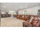 Spacious living room featuring a large sectional sofa, bar area, and dining set at 4386 Oldstone Dr, Harrisburg, NC 28075