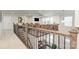 Loft view with wrought iron railing overlooking dining area at 4386 Oldstone Dr, Harrisburg, NC 28075