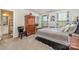 Cozy main bedroom featuring a comfortable bed, wooden armoire, and natural light from the windows at 4386 Oldstone Dr, Harrisburg, NC 28075