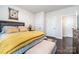 Relaxing bedroom with hardwood floors, a decorative headboard, and neutral colors at 4386 Oldstone Dr, Harrisburg, NC 28075