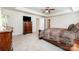 Spacious bedroom showcasing a ceiling fan, ensuite access, and neutral carpeting at 4386 Oldstone Dr, Harrisburg, NC 28075