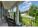 Relaxing front porch with black rocking chairs and a view of the well-manicured neighborhood at 4386 Oldstone Dr, Harrisburg, NC 28075