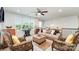 Relaxing sitting area with comfortable seating, neutral carpeting, and recessed lighting at 4386 Oldstone Dr, Harrisburg, NC 28075