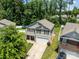 Aerial view of a well-maintained two-story home with a lush green yard, complemented by mature trees and a private backyard at 5009 Granite Creek Ln, Charlotte, NC 28269