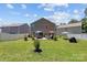 Spacious backyard featuring patio with dining set and lush lawn at 5009 Granite Creek Ln, Charlotte, NC 28269
