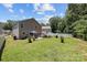 Backyard with patio, mature trees, and partial fencing at 5009 Granite Creek Ln, Charlotte, NC 28269