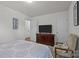 Bedroom featuring neutral carpet, TV, chair, and minimalist decor art at 5009 Granite Creek Ln, Charlotte, NC 28269