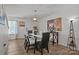 Bright dining room with a stylish light fixture and ample natural light, creating a welcoming space for meals and gatherings at 5009 Granite Creek Ln, Charlotte, NC 28269